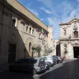 L'edificio, oggi occupato dal Tribunale per i minorenni, si trova nel cuore dell'isola che ospita il centro storico del capoluogo jonico. Sorge in piazza Duomo, affiancato dalla cattedrale di San Cataldo